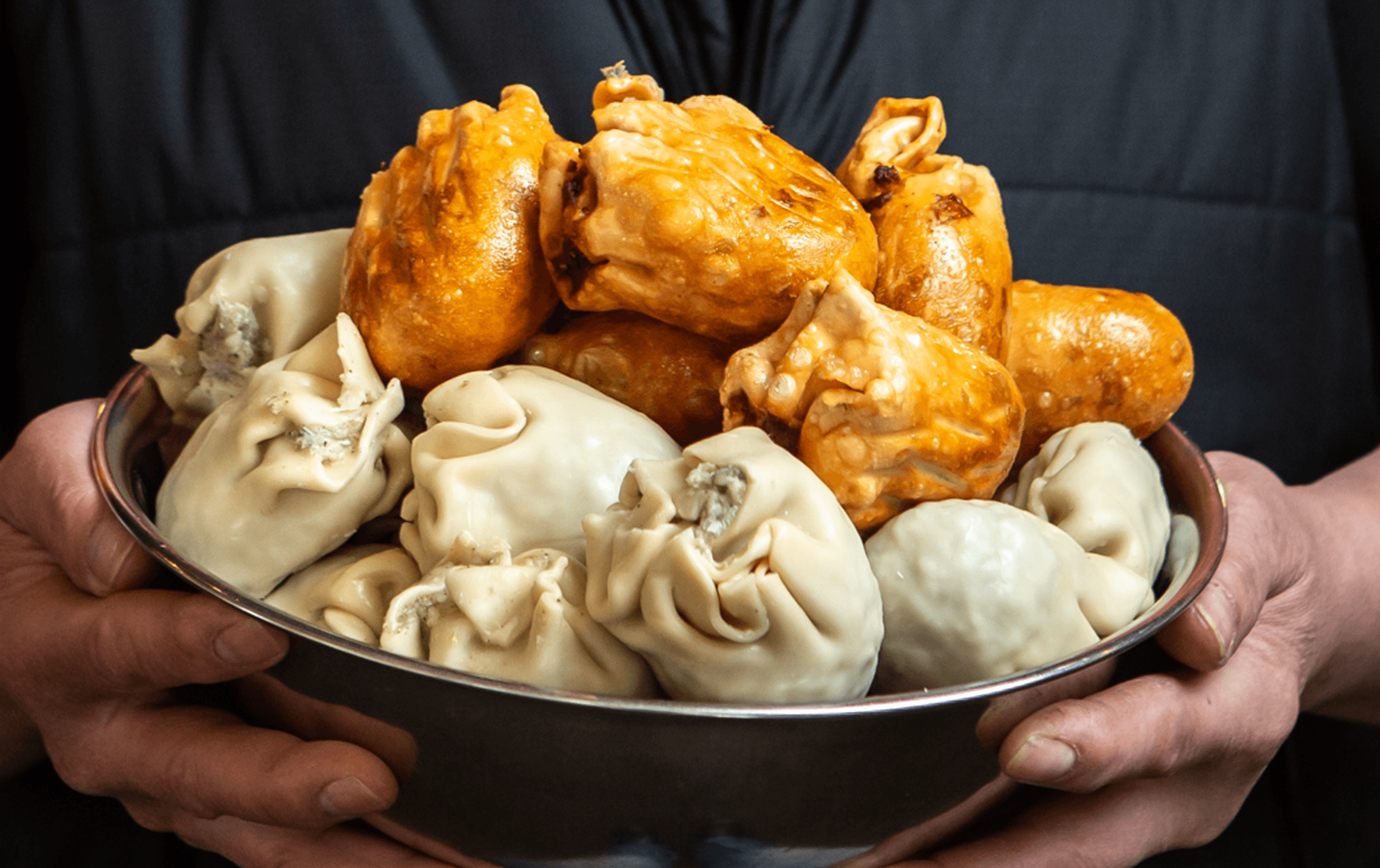 A bowl of fried and uncooked dim sims.